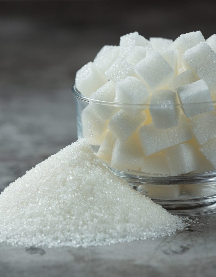 World diabetes day;Sugar cubes in a glass bowl on dark floor