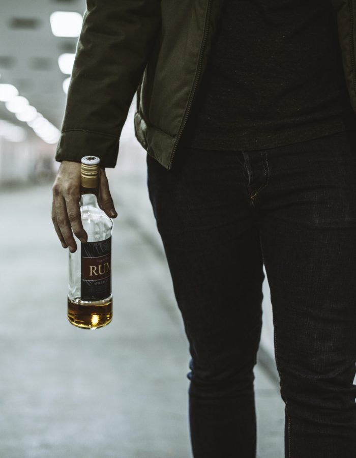 Alcoholic Homeless Holding Liquor Bottle