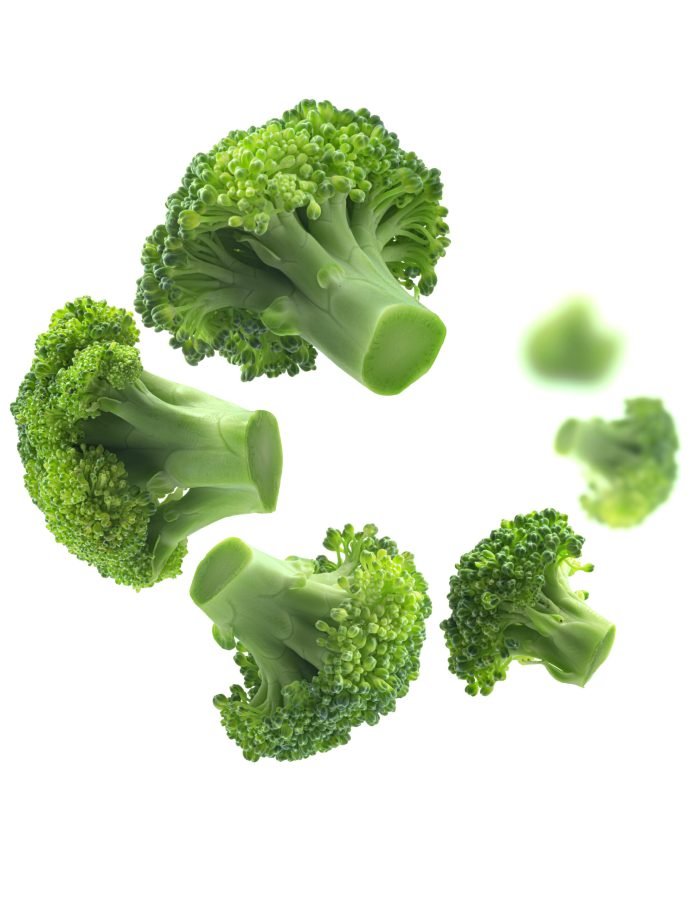 Green broccoli levitating on a white background.