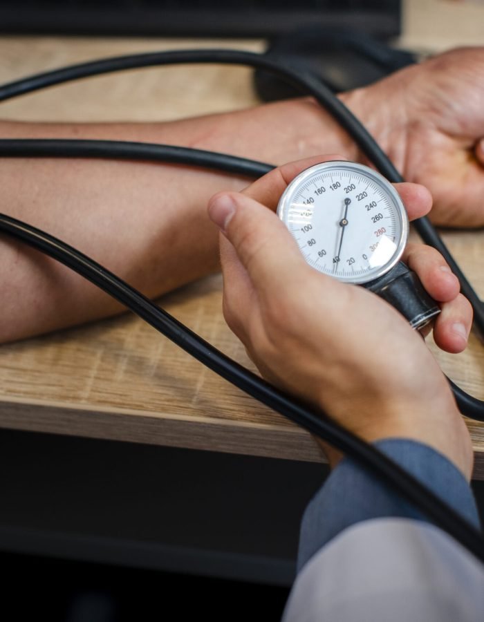 male-doctor-hand-measuring-tension