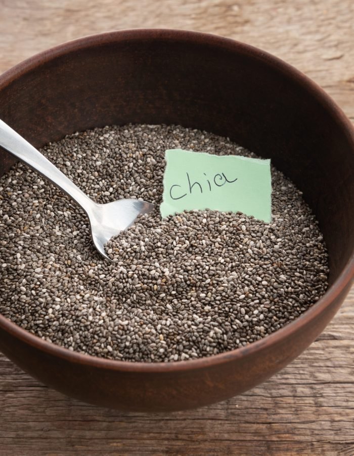 Nutritious chia seeds in a bowl on wooden background